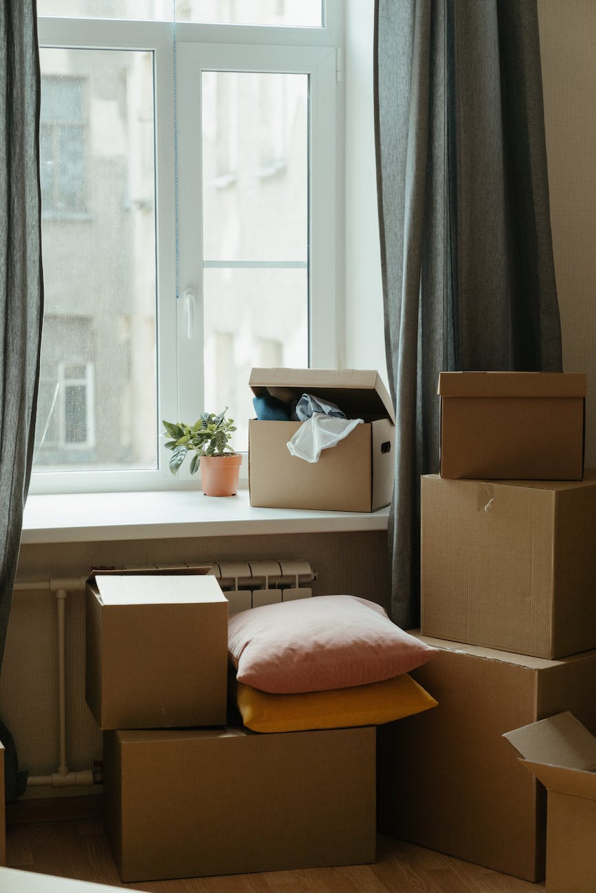 brown cardboard box on white bed